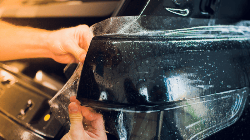 A person is applying a car wrap.