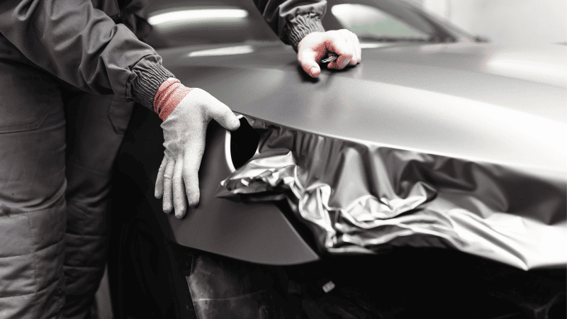 A man is installing car film.