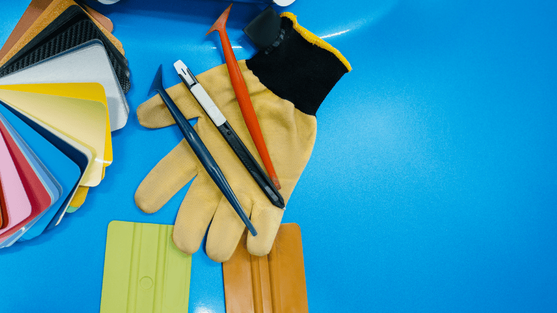plastic or rubber wrap removal tools, gloves and two plastic scrapers