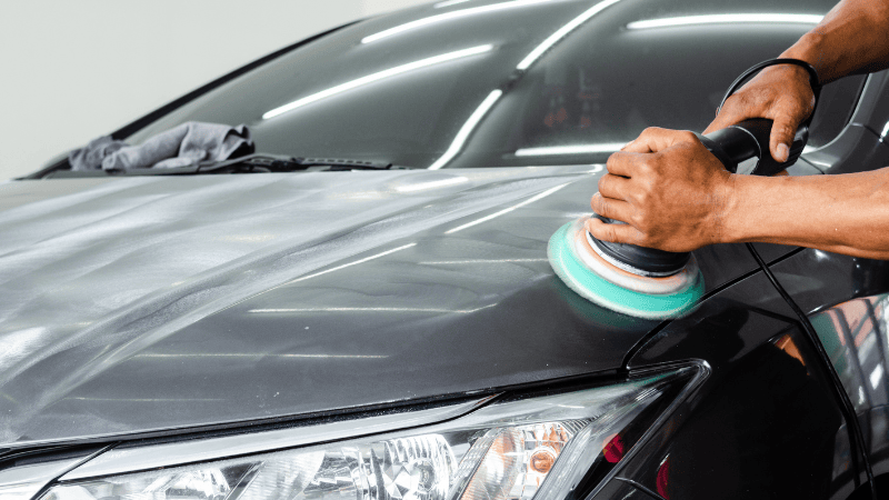 A man is buffing the car's PPF.
