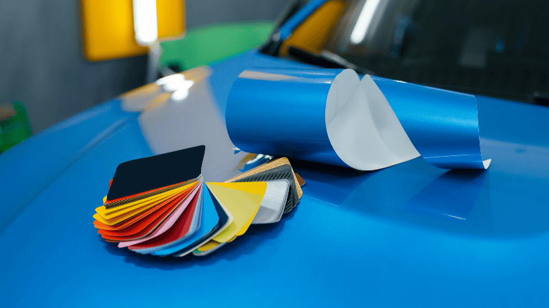 Many colorful car vinyl wraps on a car