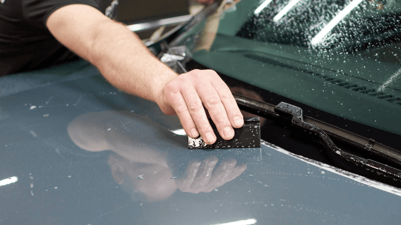 A man is washing the car.