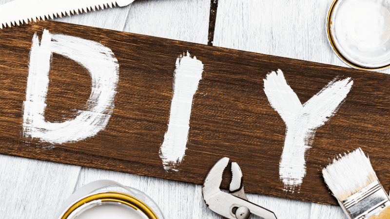 A board with "DIY" painted on it.