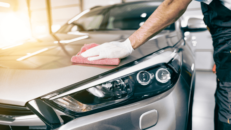 A man is cleaning the car.
