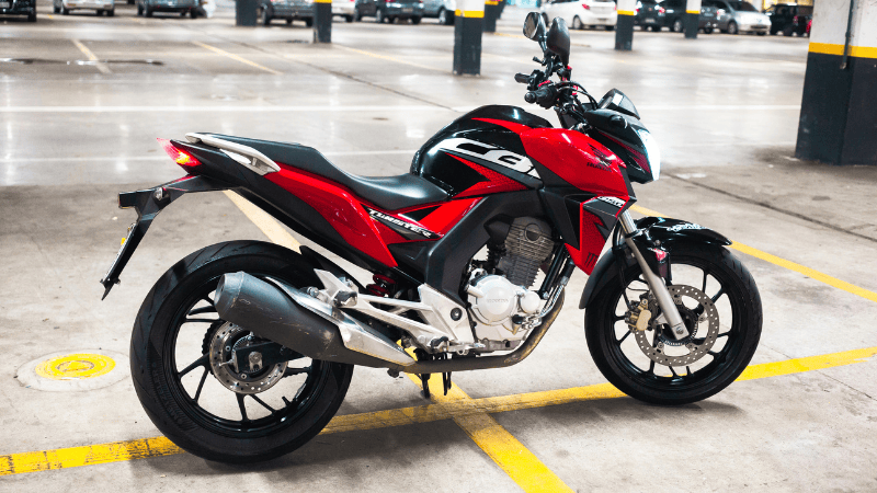 A motorbike with black and red wraps
