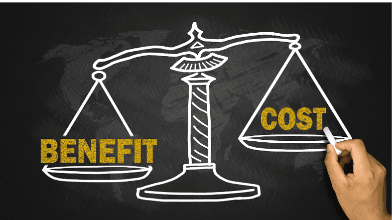 A person drew a balance on the blackboard with BENEFIT and COST on the left and right, respectively.