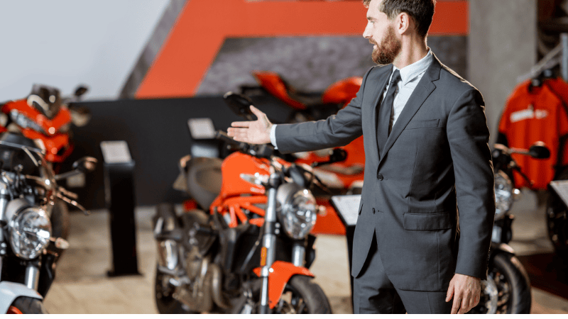 A seller is introducing the motorcycles.