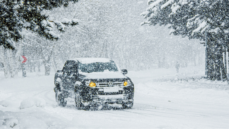 A black car on the snowy road