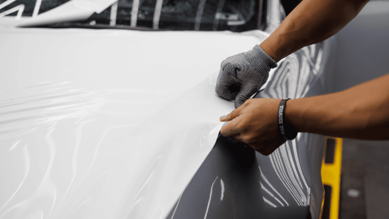 A man is wrapping a car.