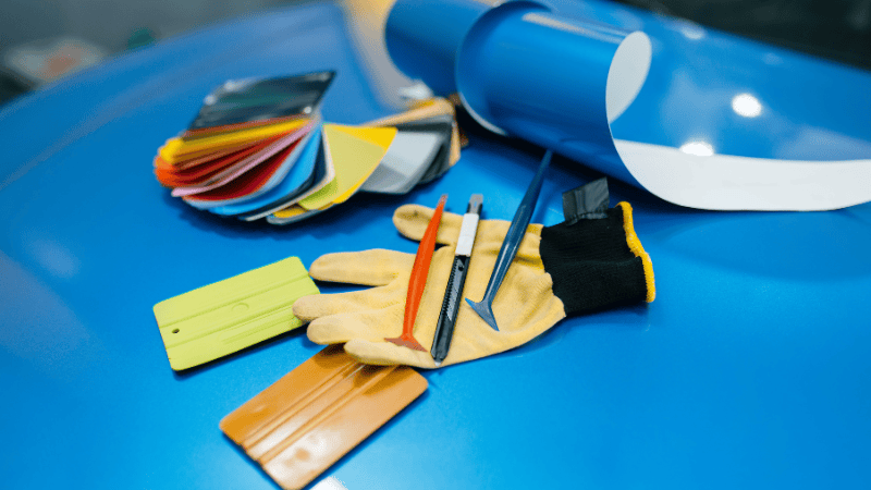 Vinyl wraps, squeegee, a wrap cutter and gloves.