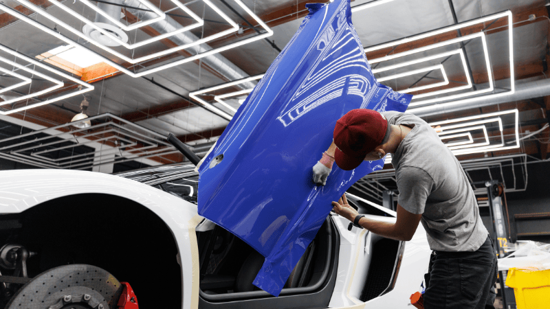 A man is wrapping the car.