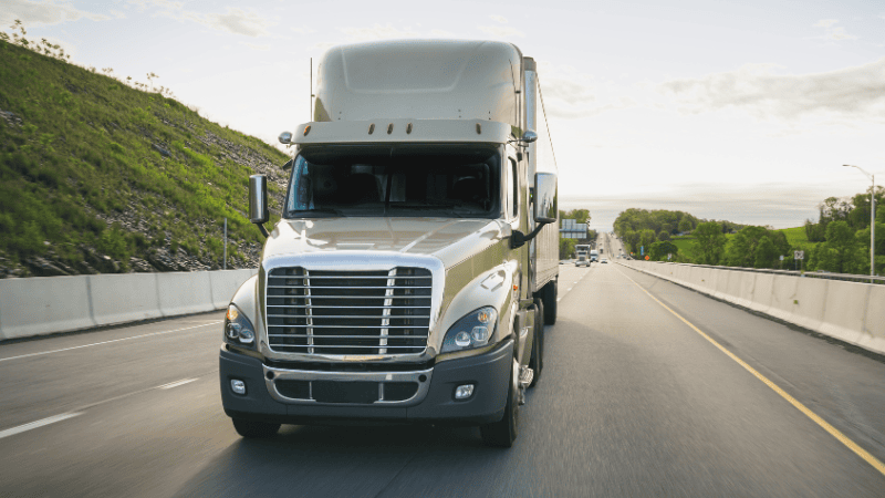 A green truck is on the road with PPF's protection.