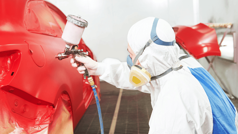 A man is repainting the car.