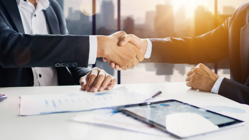 The two men are shaking hands after good communication.