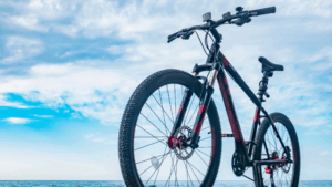 A bike in a vinyl wrap is on the beach.