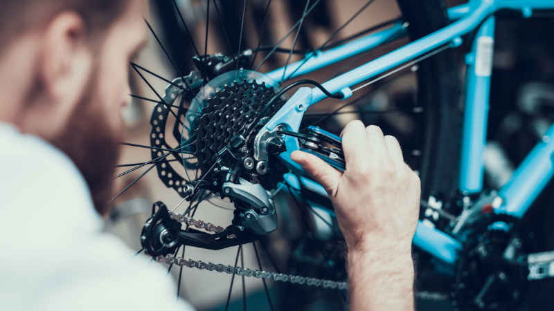 A professional is wrapping the bike with vinyl wraps.