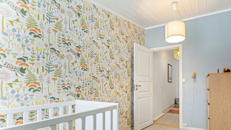 The walls of the room are covered with wall films with flowers and plants patterns.