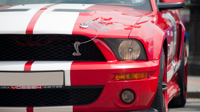 A Ford Mustang in red vinyl wrap