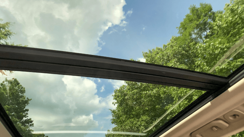 The car's sunroof keeps out the glare and the heat from the blazing white clouds.