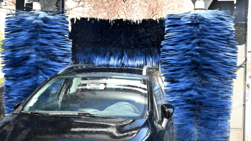 Vehicles being washed in self-service washers