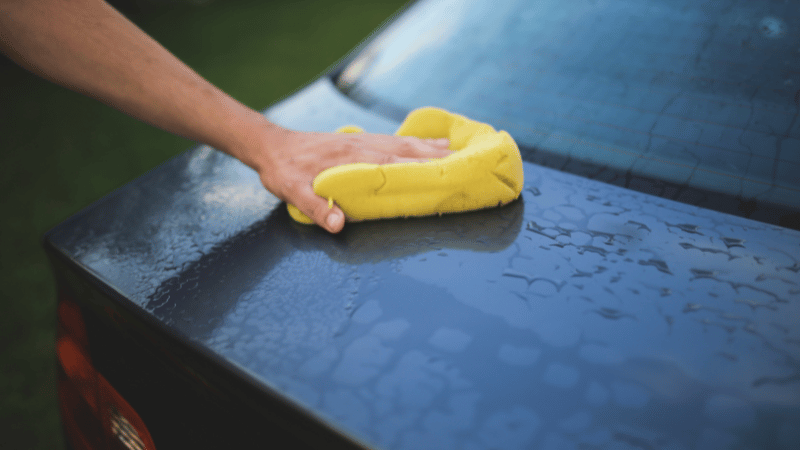 wipe the car with a sponge