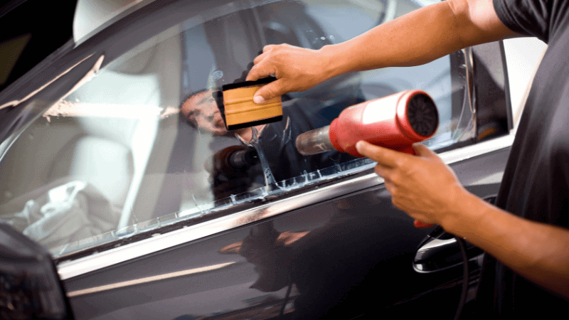 Using a squeegee while tinting can help press down the bubbles