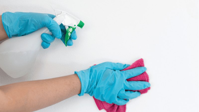 A man is cleaning the wall decals.