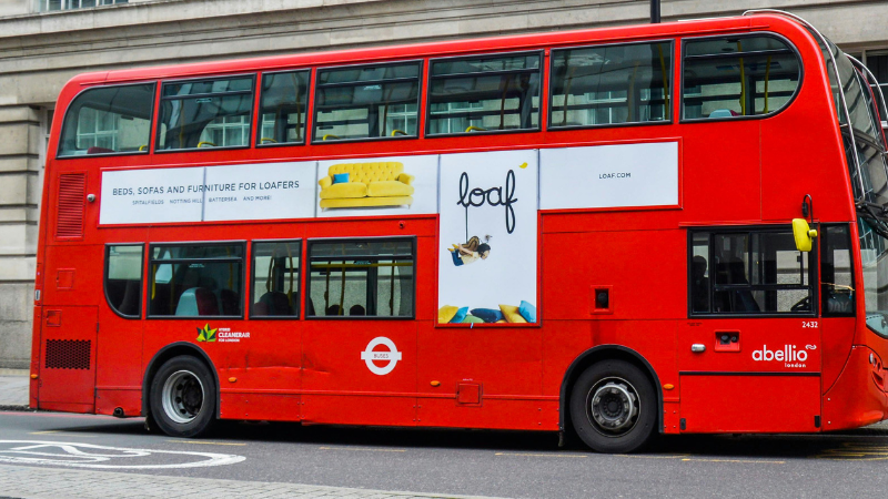 The side view of a bus in advertisement wraps