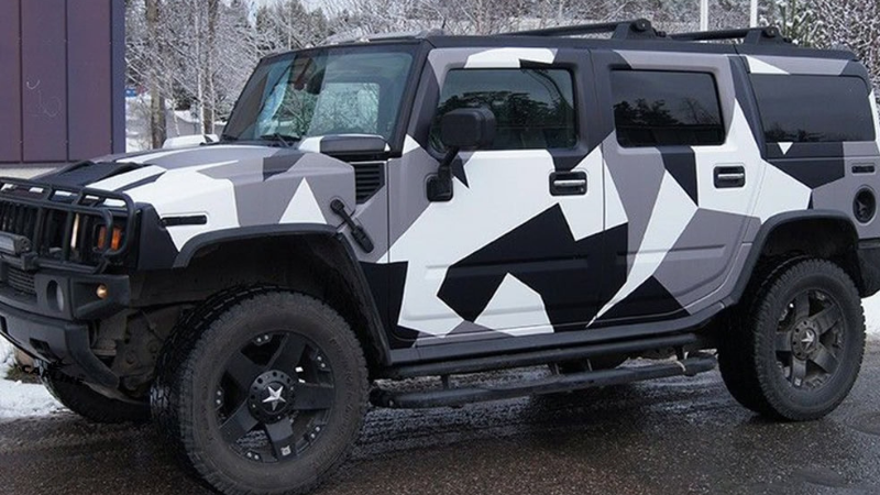 A jeep wrapped in arctic camouflage wrap