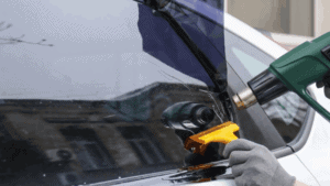 A man is applying ceramic tint.